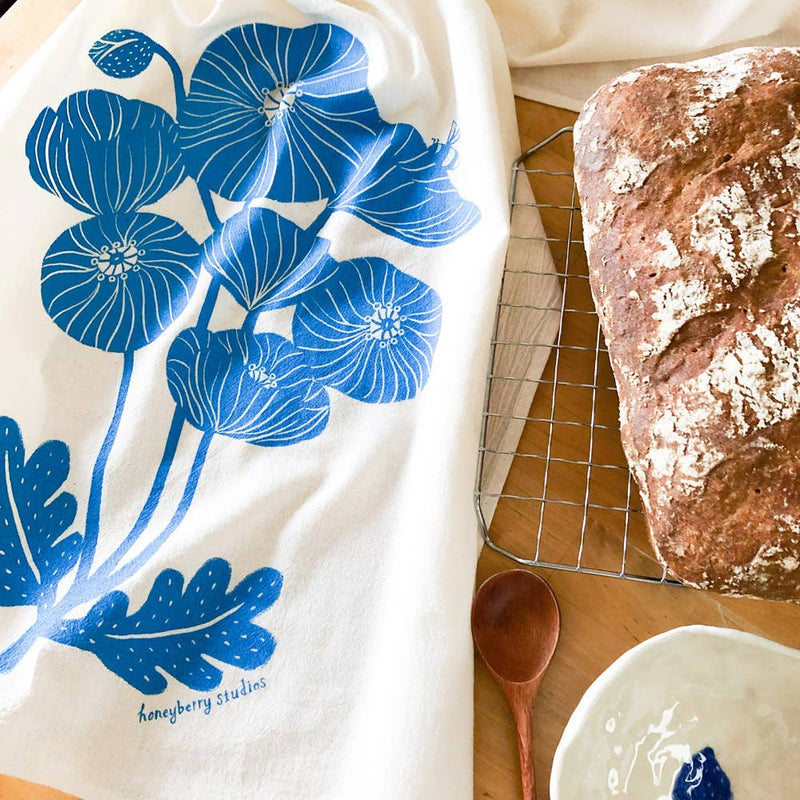 Tea towel with blue poppy design